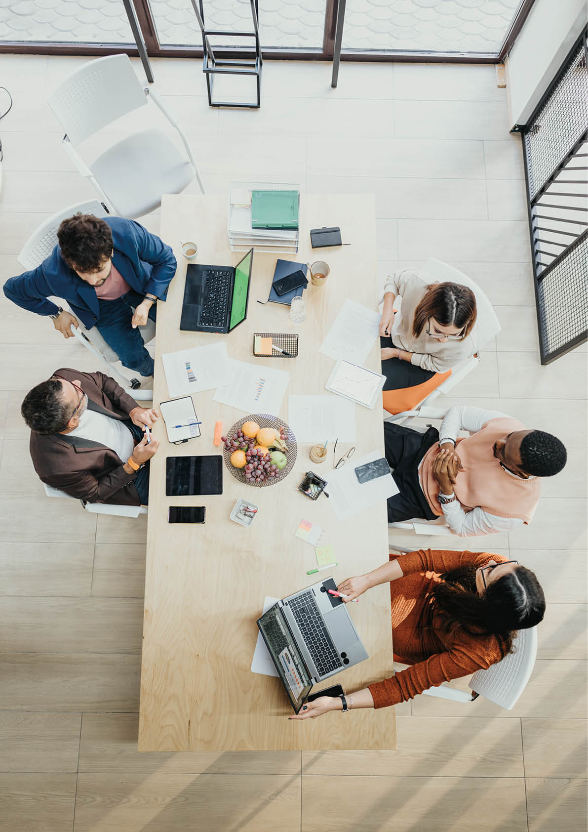 Multinational business team collaborates in corporate office, analyzing data and solving problems  Successful teamwork ensures profit growth and project progress 