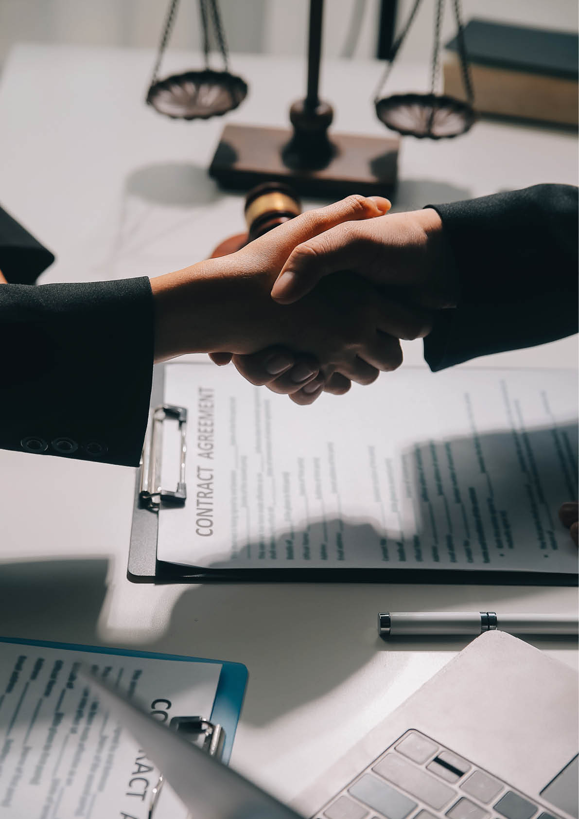 Businessman shaking hands to seal a deal with his partner lawyers or attorneys discussing a contract agreement