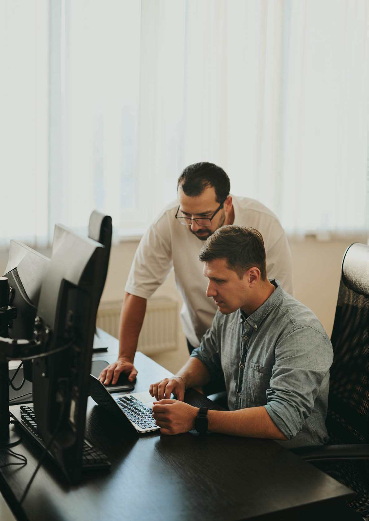 Portrait of two professional male programmers working on computer in diverse offices  Modern IT technologies, development of artificial intelligence, programs, applications and video games concept