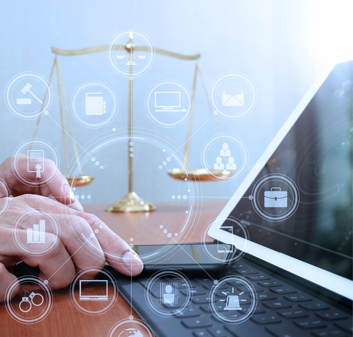 justice and law concept Male lawyer in office with the balance brass scale,hand working with smart phone and digital tablet computer on wooden desk,virtual graphic icons screen diagram