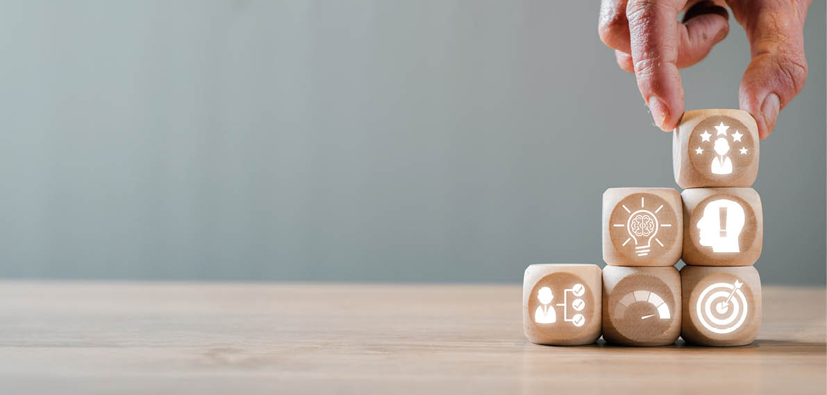 Hand arranging wooden blocks with competence concept icons, symbolizing skills, growth, and success in business and personal development 