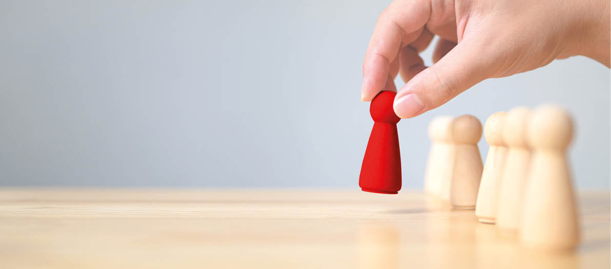 Human resource, Talent management, Recruitment employee, Successful business team leader concept  Hand chooses a wooden people standing out from the crowd