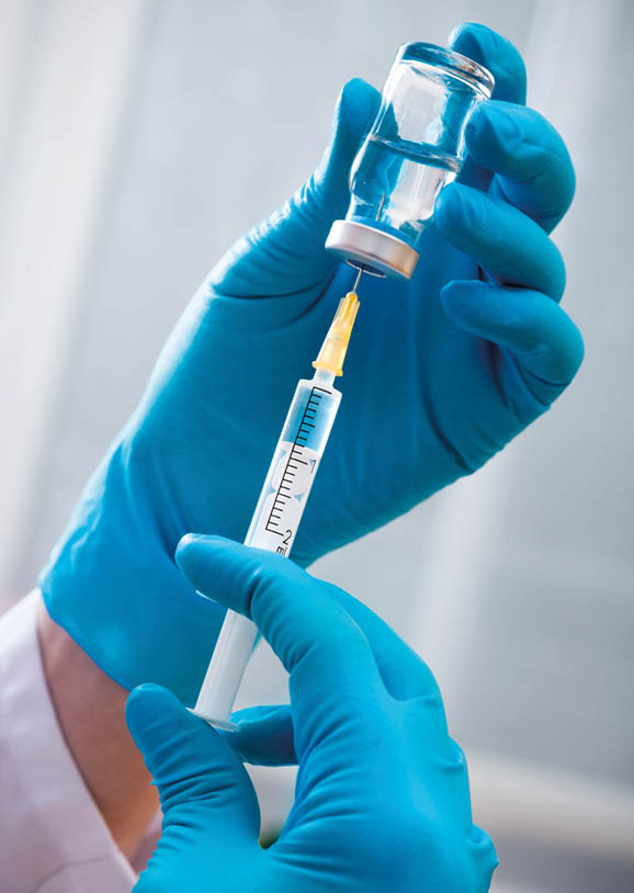 Hands of the doctors filling a syringe