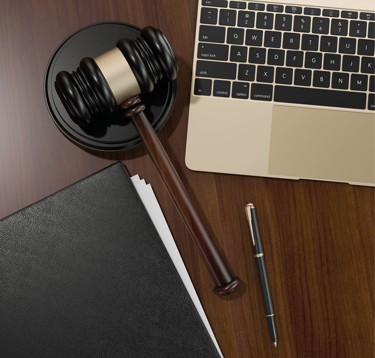 Wooden judges gavel and laptop on the brown wooden background  High resolution