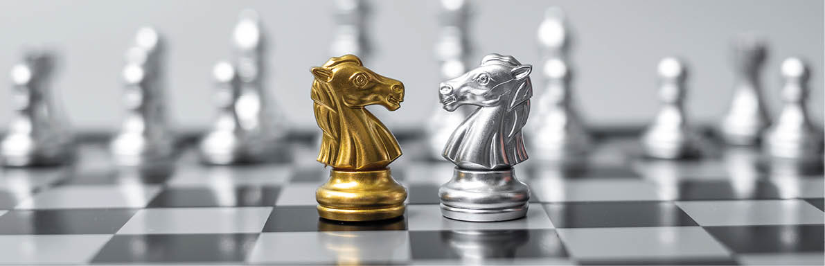 Gold and silver Chess Knight (horse) figure on Chessboard against opponent or enemy  Strategy, Conflict, management, business planning, tactic, politic, communication and leader concept
