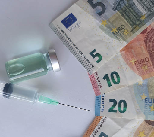 european banknotes, syringe and bottle with medicine