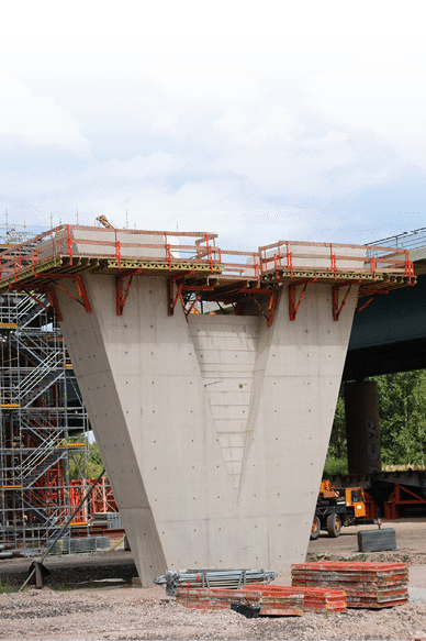 The construction of a new highway bridge with a V-shaped concrete beam              