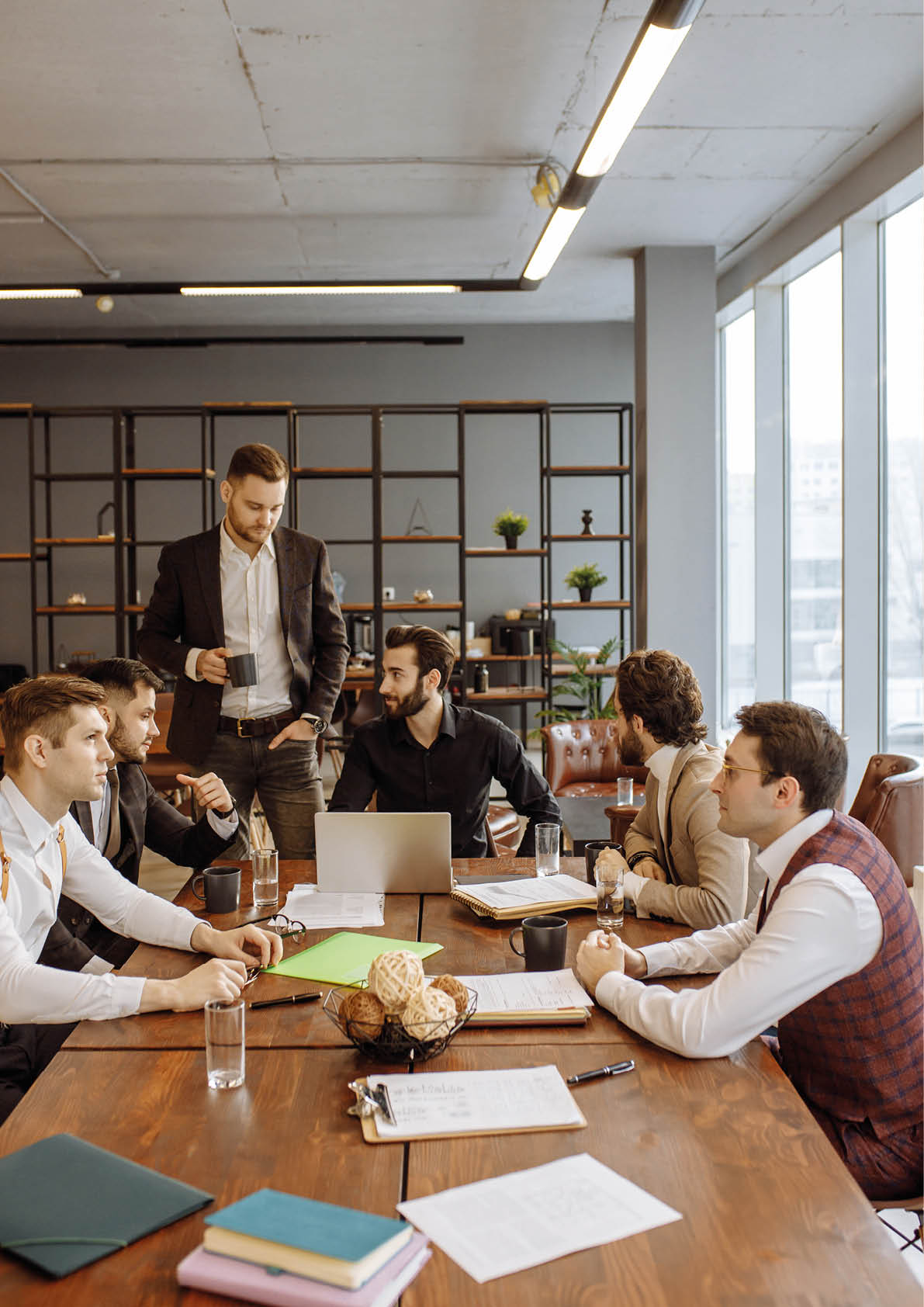 serious business people hold meeting in office for discussing and speaking about business projects, ideas and strategies for future  successful confident men in elegant suits indoors