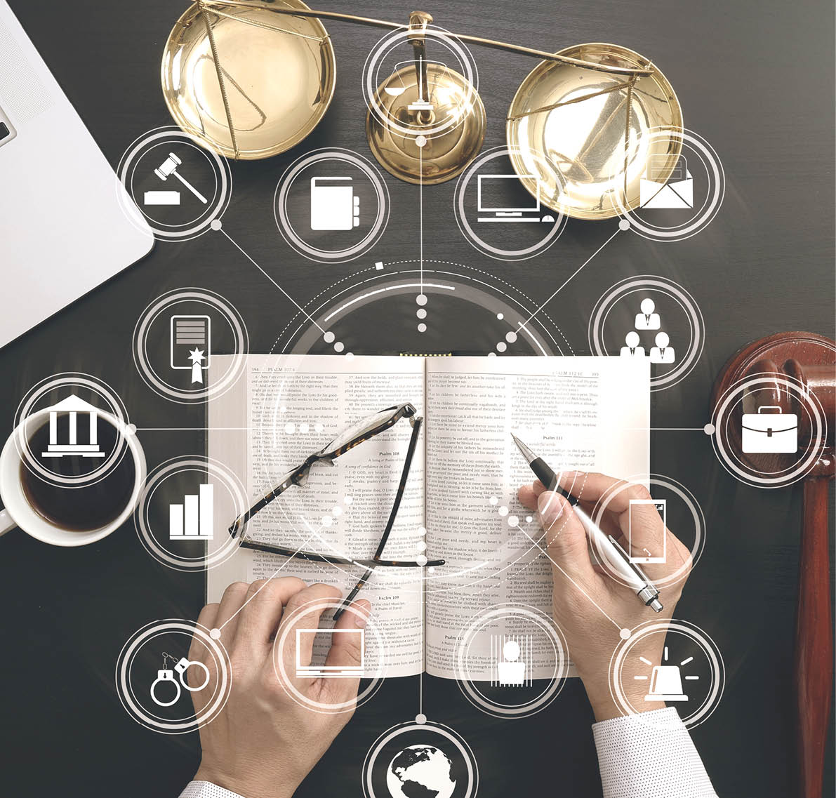 justice and law concept Top view of Male judge hand in a courtroom with the gavel and brass scale and computer and open bible book on dark wood table with Vr diagram