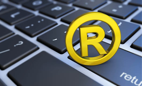 Business registered trademark concept with golden symbol and icon on a computer keyboard 3D illustration 