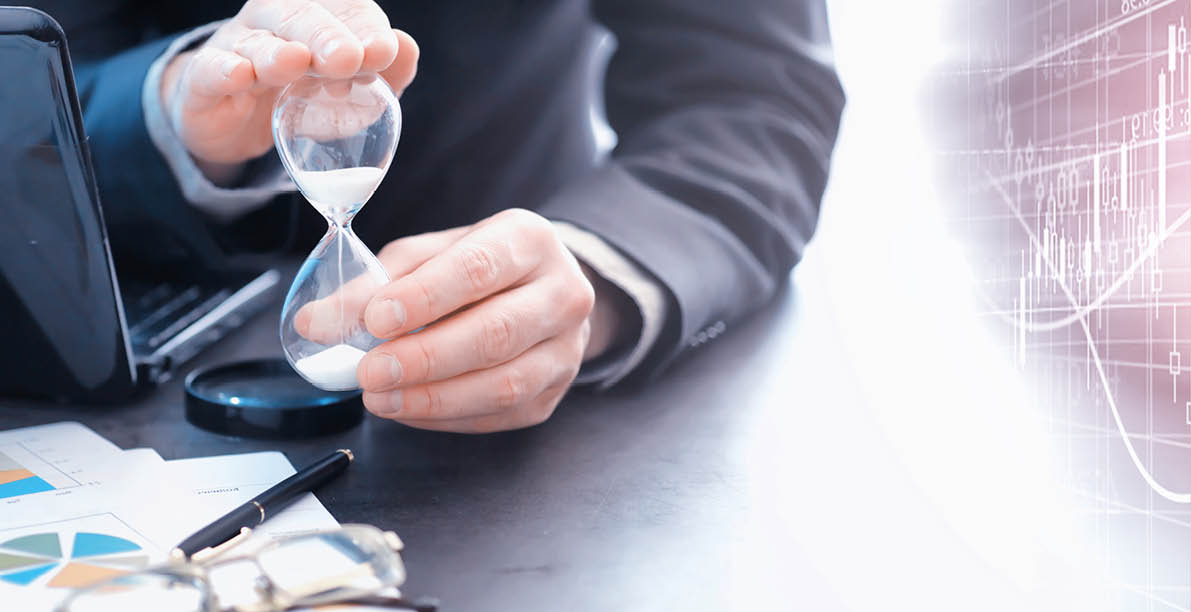 Working time symbolizes an hourglass  Office desk with insurance manager and banker  Office employee at the table  The concept of lack of time 