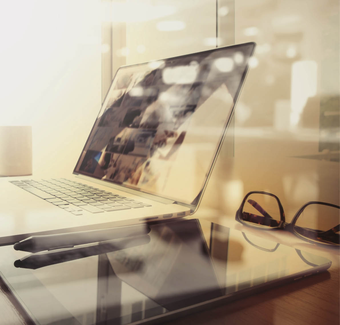 Office workplace with laptop and smart phone on wood table and london city blurred background  