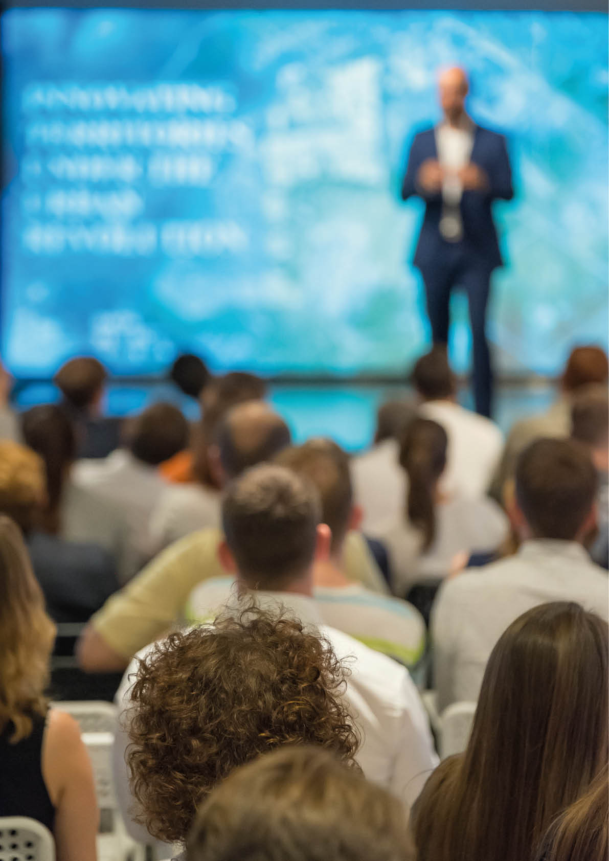 Audience listens to the lecturer at the conference hall