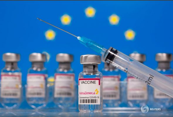 En esta ilustración, tomada el 10 de marzo de 2021, se ven frascos con la etiqueta "Vacuna contra el coronavirus Astra Zeneca COVID-19" y una jeringa frente a una bandera de la UE que se muestra. REUTERS / Dado Ruvic / Ilustración