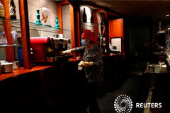 España relaja el confinamiento para la mitad de la población Maria Vazquez wears a face mask as she cleans her restaurant before trying to reopen it from May 11, as some Spanish provinces are allowed to ease restrictions amid the coronavirus disease (COVID-19) outbreak, in Guadalajara, Spain, May 10, 2020