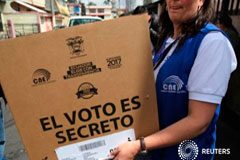 Moreno y Lasso necesitarían una segunda vuelta en las elecciones de Ecuador Una trabajadora del Consejo Nacional Electoral lleva material electoral en Quito, el 17 de febrero de 2017