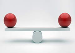 Dos bolas rojas en equilibrio sobre una tabla