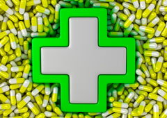 Cruz de farmacia sobre píldoras