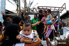 Los supervivientes del tifón piden ayuda, pero el rescate es difícil Unos soldados ayudan a unos residentes a salir de Tacloban, una de las zonas más afectadas por el tifón, el 11 de noviembre de 2013