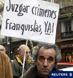 un hombre sostiene una pancarta durante una protesta a favor del juez de la Audiencia Nacional Baltasar Garzón frente a la Audiencia Nacional en Madrid, el 14 de abril de 2010, que se enfrenta a una posible inhabilitación por intentar investigar los críme