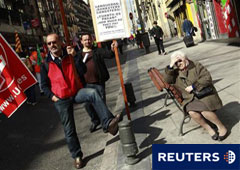 Una mujer contempla una manifestación de trabajadores de Aena que protestan en el centro de Madrid el 26 de febrero de 2011.