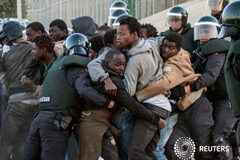 Una veintena de inmigrantes acceden a Melilla tras un nuevo salto a la valla Inmigrantes subsaharianos rodeados por la Guardia Civil española en el puesto fronterizo entre Marruecos y Melilla, el 24 de abril de 2014