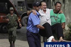 Los muertos por las inundaciones en Brasil superan los 700 Unos hombres trasladan a un herido en Nova Friburgo, el 17 de enero de 2011.