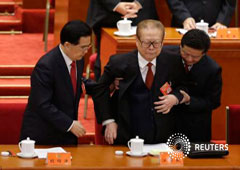 El presidente chino Hu Jintao (izq.) y un asistente ayudan al expresidente Jiang Zemin (centro)