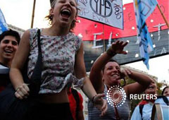 manifestantes del grupo político JP Evita marchan bajo una pancarta que dice 