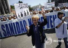 Miles de personas se manifestaron por las calles de Madrid el domingo en defensa de la sanidad pública y contra las medidas del gobierno autonómico para privatizar algunos hospitales y centros medicos. Imagen de una participante en la manifestación del 21