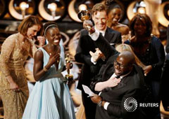 El director y productor Steve McQueen (D) celebra el Oscar a mejor película junto a la actriz Lupita Nyong