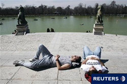varias personas toman el sol en el parque del Retiro, en Madrid, pocos días antes del comienzo de la primavera, el 17 de marzo de 2010.
