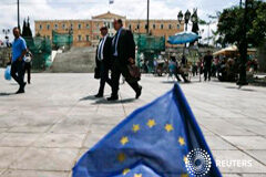 Alemania dice que un referéndum en Grecia sobre las reformas podría ayudar Varias personas pasan jnto a una pequeña bandera de la ÚE en la plaza de la Constitución de Atenas, el 11 de mayo de 2015