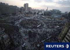 Coches intentan cruzar la plaza deTahrir en El Cairo a última hora, el 13 de febrero de 2011.