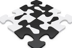 Un tercio de las compañías españolas crecerá a través de fusiones y adquisiciones 4 fichas de puzzle unidas, dos blancas y dos negras cada una con el dibujo de una corbata