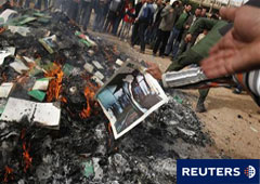 Manifestantes antigubernamentales queman una foto de Gadafi en Bengasi, el 2 de marzo de 2011.
