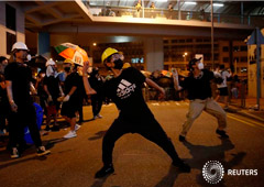 An anti-extradition demonstrator throws an egg at a police station, after a march to call for democratic reforms in Hong Kong, China July 21, 2019.