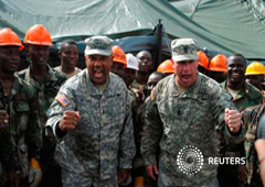 El general Darryl Williams (izq), el jefe de las tropas de EEUU en Liberia, anima a los soldados liberianos en un centro de tratamiento de ébola bajo construcción en Tubmanburg el 15 de octubre de 2014