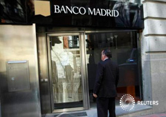Un hombre en la entrada de una sucursal cerrada de Banco Madrid, el 16 de marzo de 2015