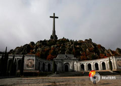 A woman holds an umbrella at the Valle de los Caidos (The Valley of the Fallen), the mausoleum holding the remains of former Spanish dictator Francisco Franco, on the 43rd anniversary of his death in San Lorenzo de El Escorial, outside Madrid, Spain, Nove