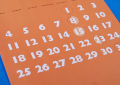 Una hoja de calendario de color naranja y están marcados dos días con círculo