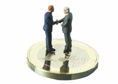 Figuras de dos personas dándose la mano sobre una moneda