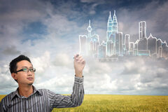 Acerca del impuesto por incremento de valor de terrenos de naturaleza urbana Un campo y una persona dibujando en el aire un conjunto de edificios