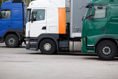 Actualización del precio del transporte ante variaciones del gasóleo Tres camiones en un aparcamiento.