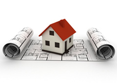 Una casita encima de unos planos Una casita encima de unos planos