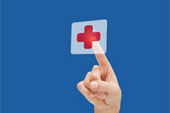 Nueva consideración geográfica en la acreditación como servicio de prevención ajeno (SPA) Un dedo pulsando en una cruz roja