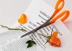 Una tijera cortando un certificado de matrimonio
