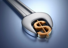 Una llave inglesa atrapando al símbolo del dólar. Una llave inglesa atrapando al símbolo del dólar.