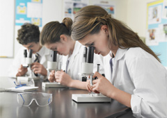 Estudiantes mirando microscopios