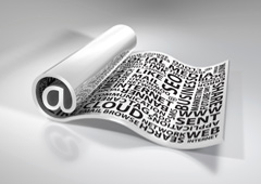 Un papel con palabras sobre internet escritas y enrollado haciendo la forma de un arroba '@' Un papel con palabras sobre internet escritas y enrollado haciendo la forma de un arroba '@'
